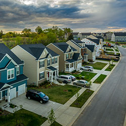 A home with several cars parked in its driveway.