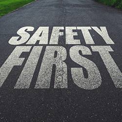 A paved road with Safety First painted on it.